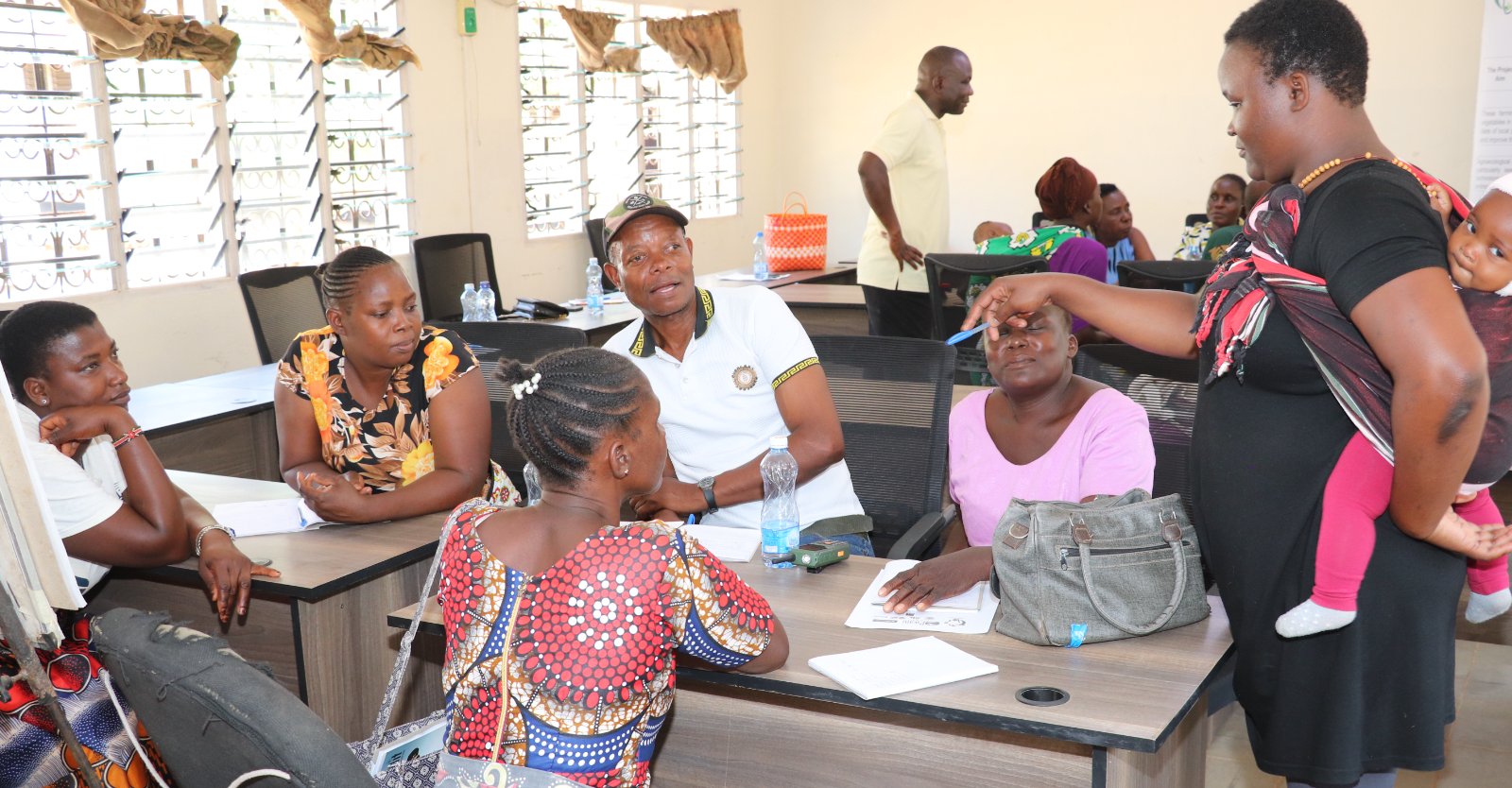 Farmers actively participating in roleplay sessions during the Agricultural Exchange Training at Pwani University.